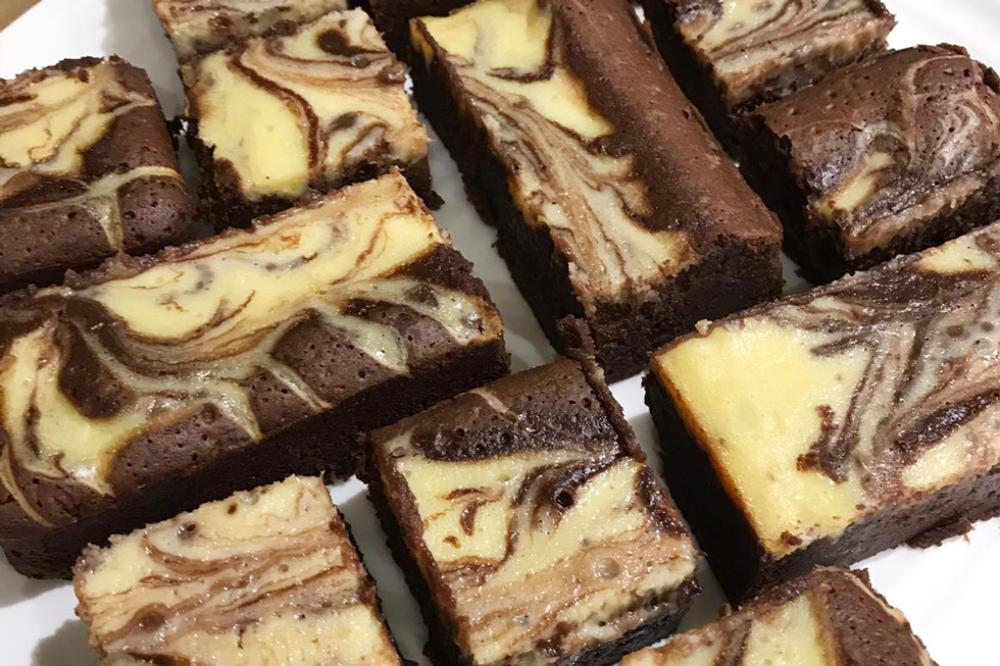 Cream cheese brownies on a white plate